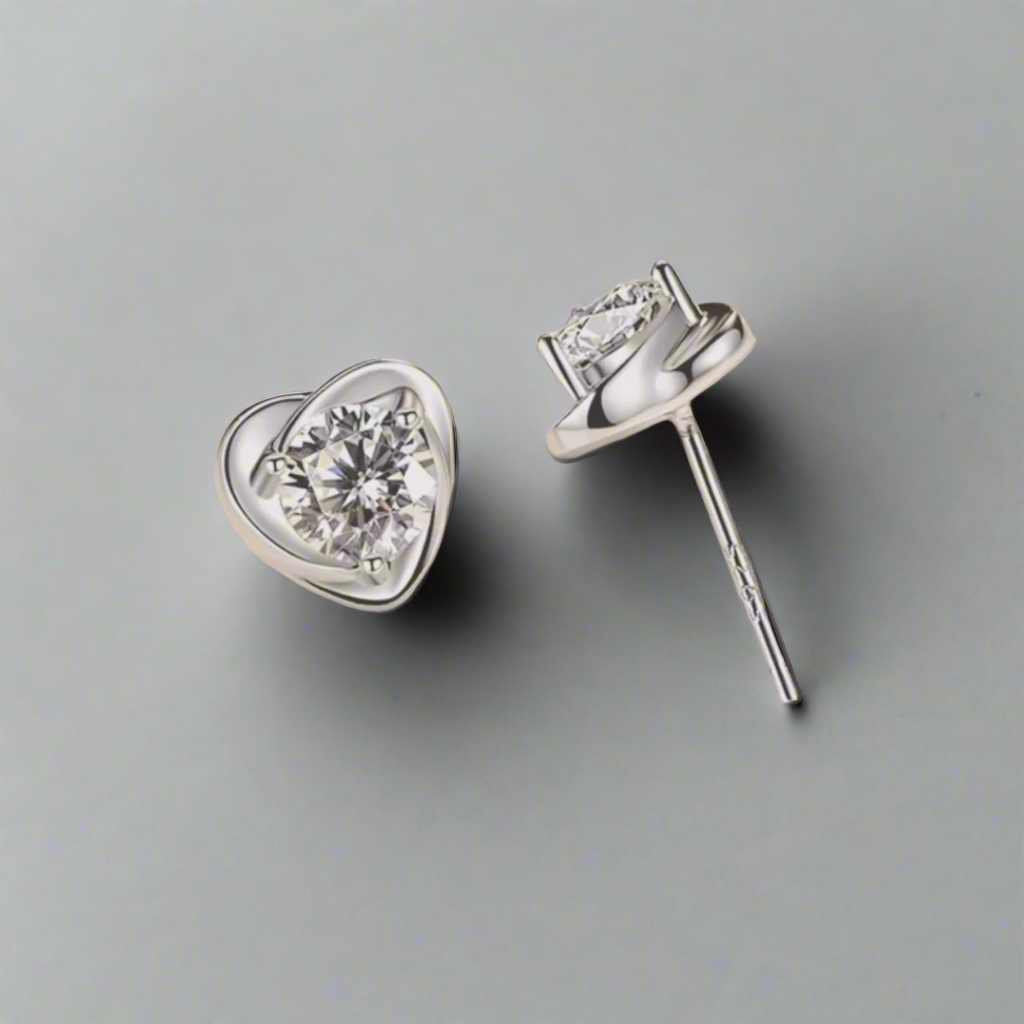 This heart-shaped sterling silver stud earring features a dazzling crystal at its center, catching and reflecting light beautifully. The sleek silver setting highlights the crystal's sparkle, creating an elegant and timeless accessory. Perfect for adding