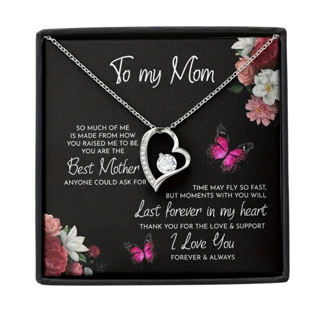 Heart Pendant For Mom-This pendant is a silver heart-shaped necklace with a round, clear cubic zirconia gemstone set within the heart's open frame. The design is elegant and simple, featuring a minimalist look that is perfect for gifting. The pendant is d
